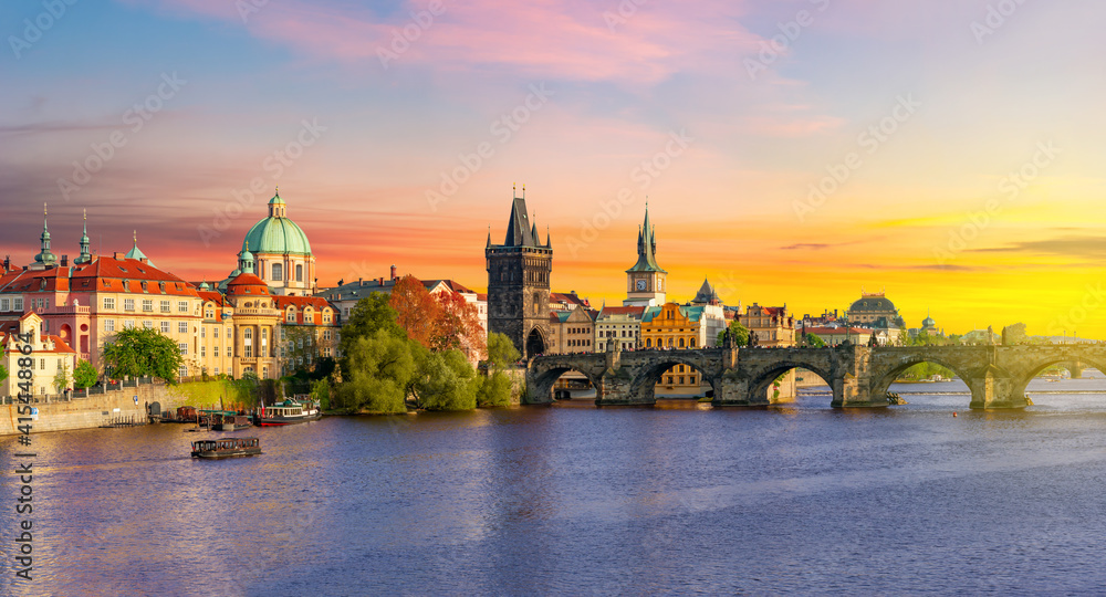 Classic Prague panorama with Old Town Bridge Tower and Charles bridge over Vltava river at sunset, Czech Republic