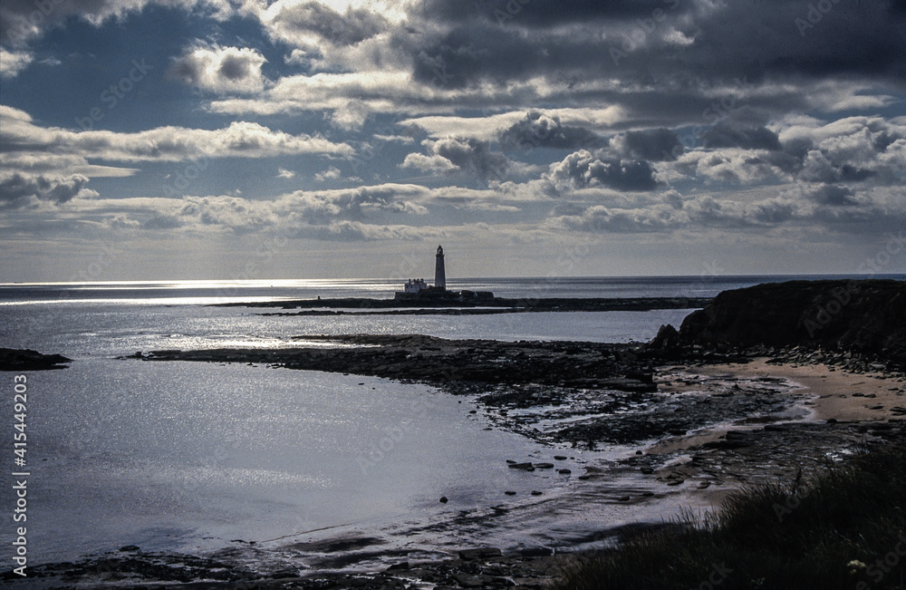 lighthouse on the shore of the sea St. Mary's Lighthouse from Old Hartley, Northumberland, England, UK, United Kingdom