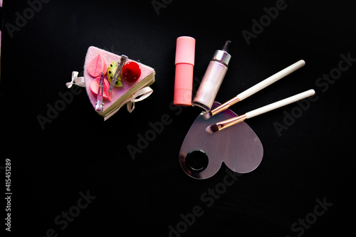 Cosmetics and accessories brush mirror on a black background. For the application of cosmetics for skin care and appearance