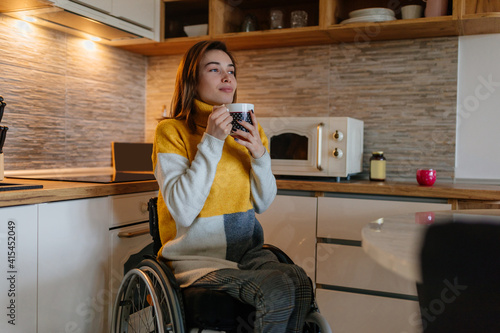 Woman in wheelchair drinking coffee photo