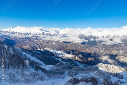 Beautiful snow landscape of snowy trees and Roza Plato village ski resort. Sochi, Russia.