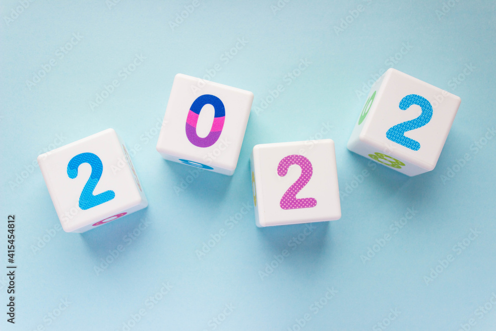 Cubes with colorful numbers 2022 on a blue background. New year, calendar. Cubes with colorful numbers 2022 on a blue background. New year, calendar.