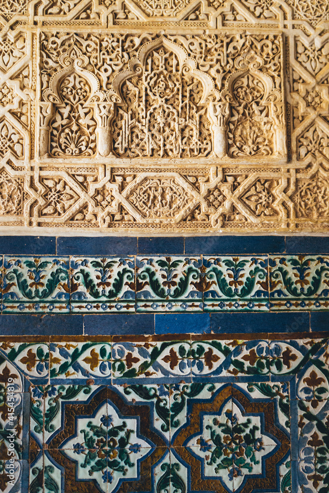 details of the arabesque decorations, typical of the moorish architecture than can be found in the Nasrid palaces of the Alhambra complex in Granada (Spain)