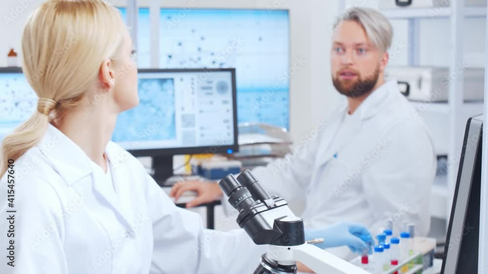 Professional team of scientists is working on a vaccine in a modern scientific research laboratory. Genetic engineer workplace. Future technology and science. Professional team of scientists is working on a vaccine in a modern scientific research laboratory. Genetic engineer workplace. Future technology and science.