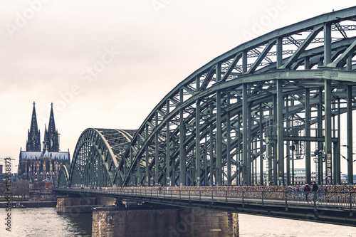 Hohenzollern Bridge over the Rhine River and Cologne Cathedral on sunset 