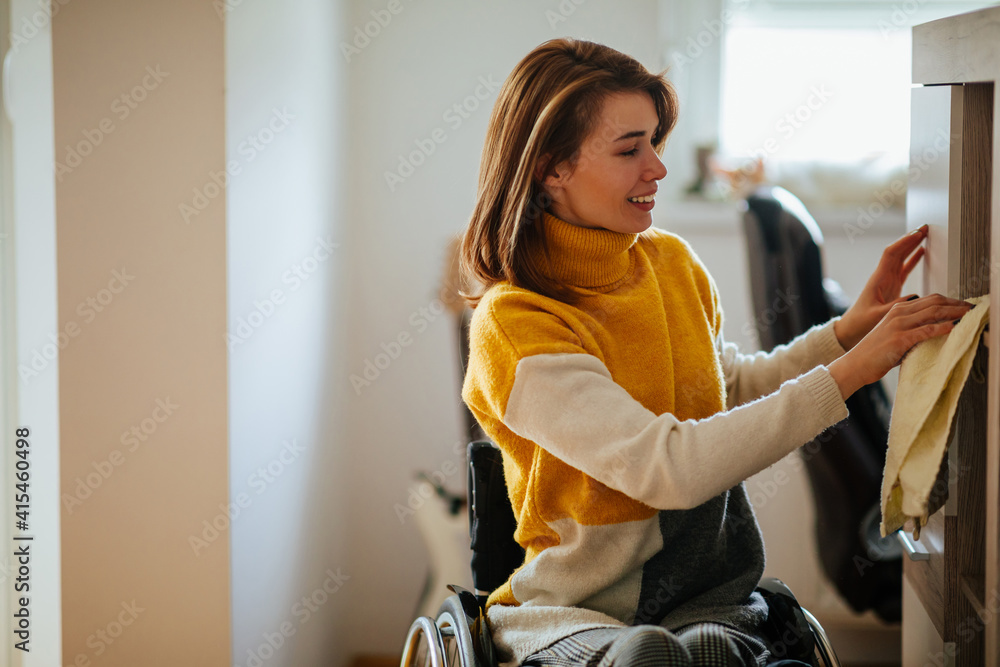 Samolepka Disabled woman wiping dust from furniture