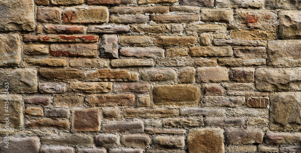 Naklejka premium Weathered wall from wild stones, retro surface