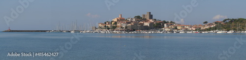Panorama of the fortified medieval village of Talamone and of its coast lapped by the Tyrrhenian Sea.