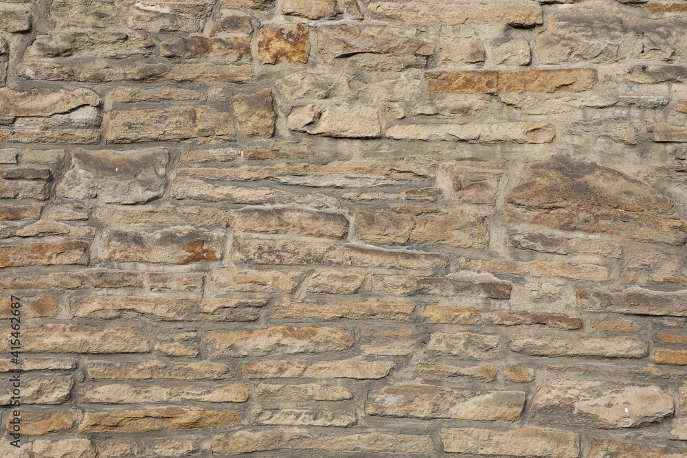 Weathered wall from wild stones, retro surface