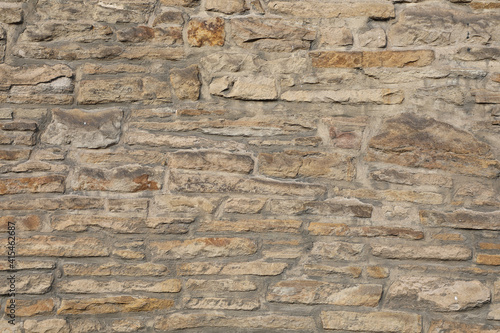 Weathered wall from wild stones, retro surface