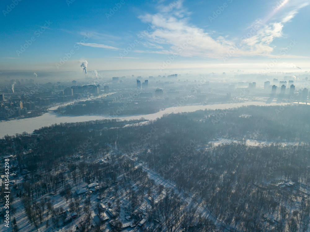 Snowy Kiev in sunny weather. Aerial drone view. Winter frosty morning.