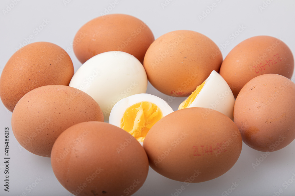 Hard boiled egg with shell and peeled boiled egg on white background Hard boiled egg with shell and peeled boiled egg on white background