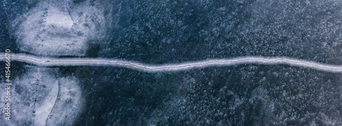 Abstract pattern of cracked ice in half, simetric texture view from top photo