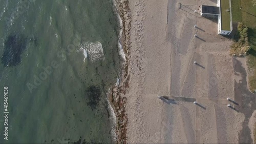 Aerial footage of the small beach Bellevue, Klampenborg, Copenhagen, Denmark. Drone fly over the beach, with sea in left side of frame, and land in right side. Camera facing down.  photo