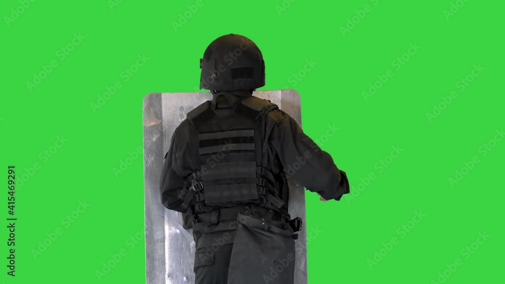 Riot police unit making sound hitting shield with baton on a Green Screen, Chroma Key. Riot police unit making sound hitting shield with baton on a Green Screen, Chroma Key.