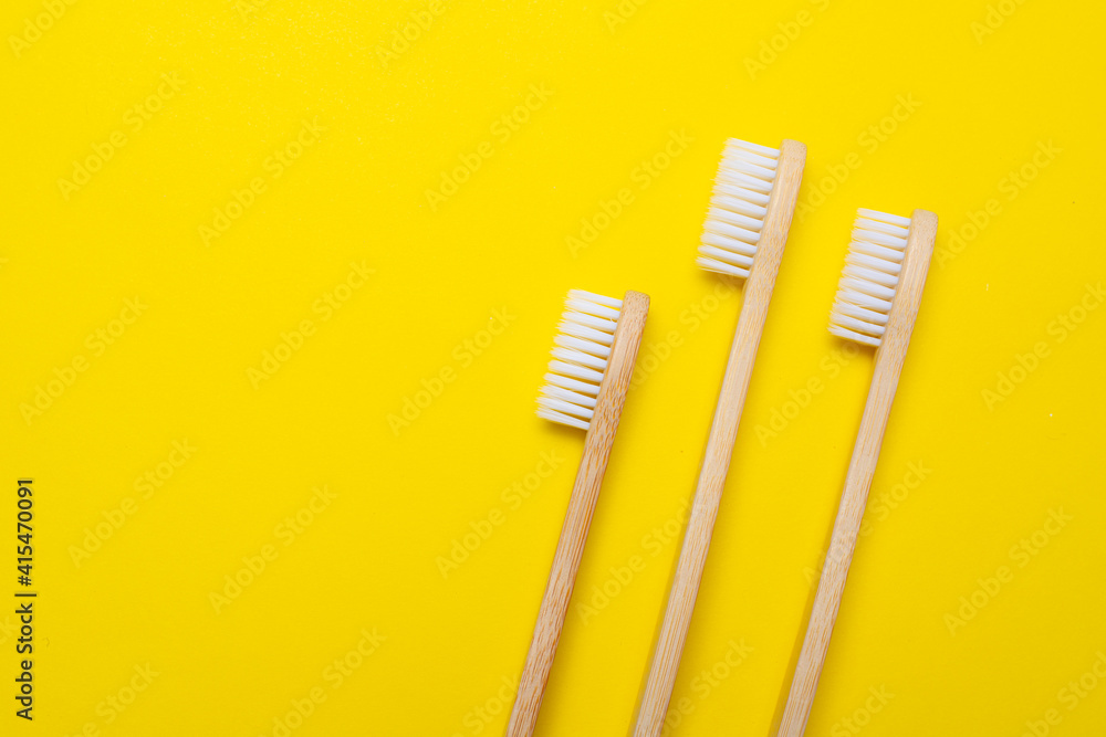 Bamboo brush on a yellow background. No plastic. Ecology. Taking care of the world around you. Toothbrush. Clean teeth. Yellow background. Copy space. of the environment. Bamboo brush on a yellow background. No plastic. Ecology. Taking care of the world around you. Toothbrush. Clean teeth. Yellow background. Copy space. of the environment.