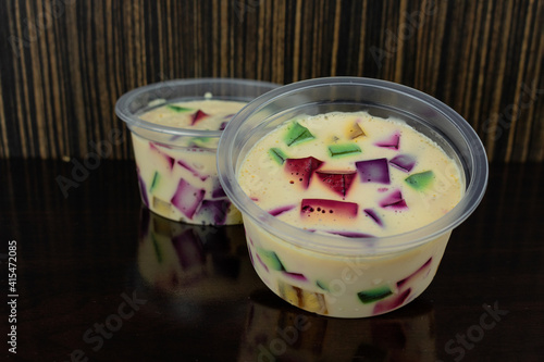 Jelly Colored, brazilian famous sweet. Colorful gelatin on wood table. Space for text.