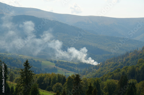 Smoke over forest in mountains © Harmony Video Pro