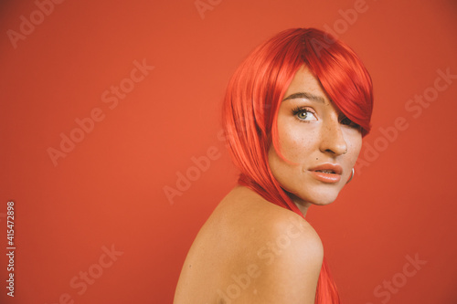 Woman with piercing looking of her shoulder