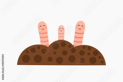 Cute earthworms happy family in garden soil.