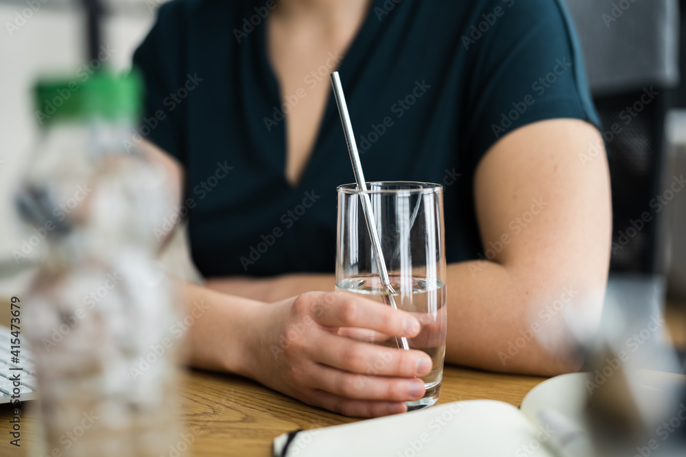 Drinking Glass On Desk And Woman In Foreground Drinking Glass On Desk And Woman In Foreground