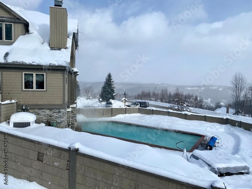 Outdoor swimming pool at Okemo mountain ski resort with fresh snow in Vermont USA photo