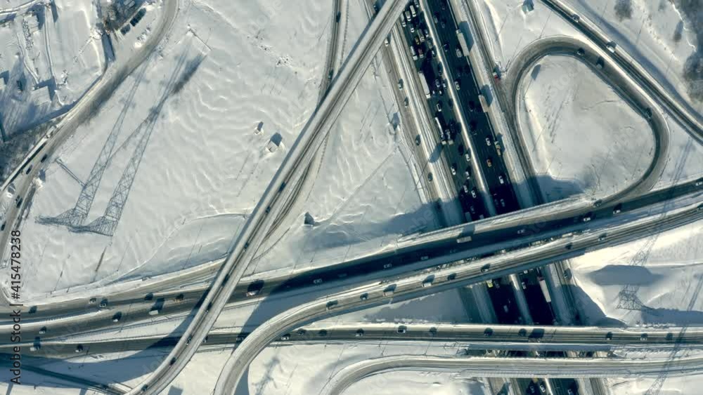 Aerial overhead view of a busy road interchange and traffic jam in snow Aerial overhead view of a busy road interchange and traffic jam in snow