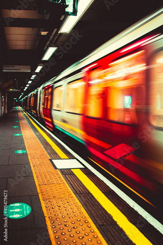 Wall Mural London UK January 2021 London Tube underground metro approaching the station platform, blurred in motion with long exposure