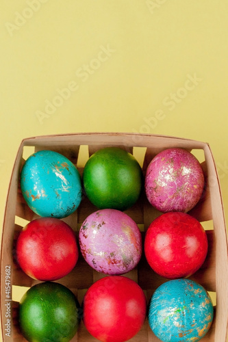 Happy Easter eggs yellow background. Golden shine decorated eggs in basket  for greeting card  promotion  poster. Copy space