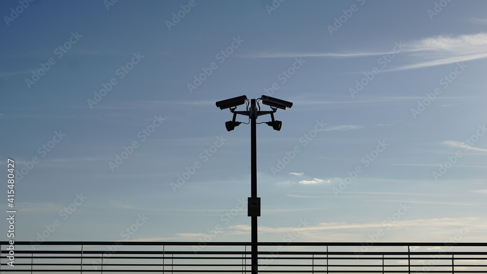 security camera silhouette on the sidewalk