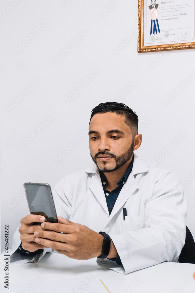 adult man dressed as a doctor or dentist, holding a phone. Online communication concept. adult man dressed as a doctor or dentist, holding a phone. Online communication concept.
