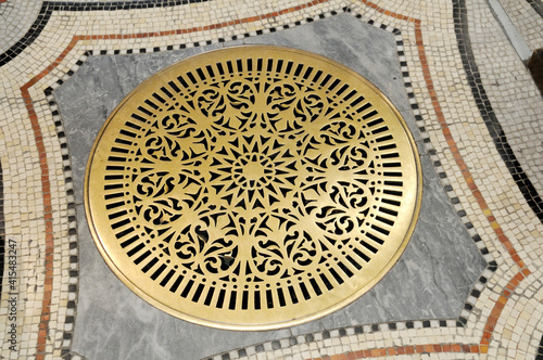 Brass grate in ceramic tile floor, Basilica Notre-Dame de Fourviere, Lyon, France photo