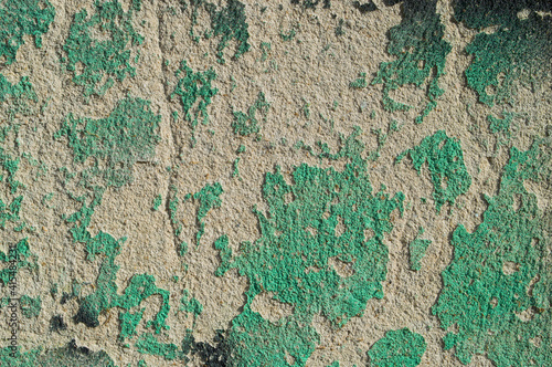 wall,with,grainy,surface,old,remnants of green paint