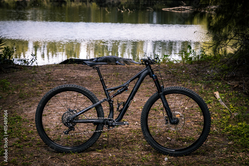 mountain bike on the trail with an alligator background photo
