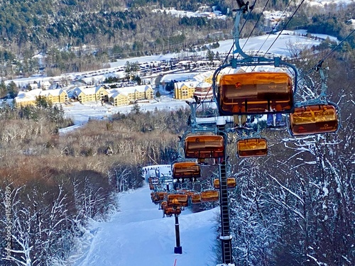 Ski chair lifts at Okemo mountain ski resort at sunny winter day in Vermont USA photo