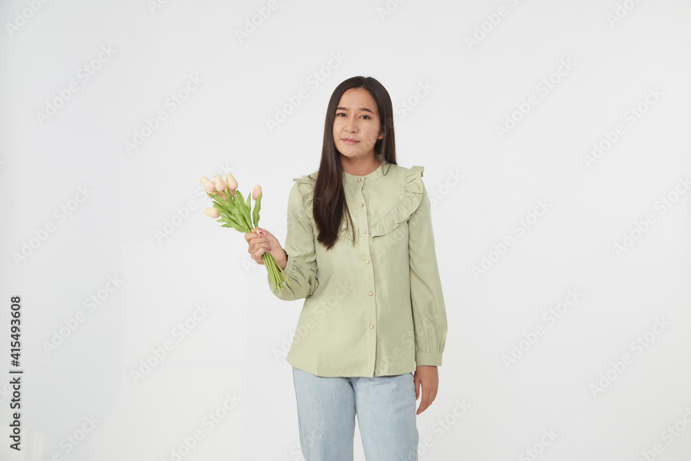 Spring Beautiful cheerful girl smiling and holding a bouquet of tulip flowers. Young happy woman. Surprise at the 8 March International Women's Day. Spring Beautiful cheerful girl smiling and holding a bouquet of tulip flowers. Young happy woman. Surprise at the 8 March International Women's Day.