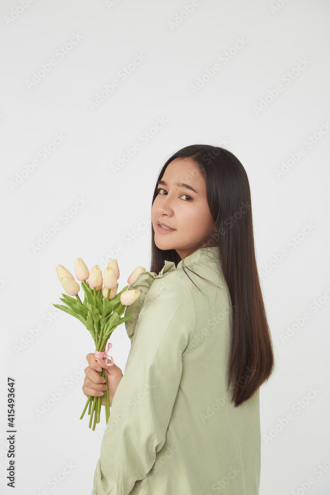 Spring Beautiful cheerful girl smiling and holding a bouquet of tulip flowers. Young happy woman. Surprise at the 8 March International Women's Day. Spring Beautiful cheerful girl smiling and holding a bouquet of tulip flowers. Young happy woman. Surprise at the 8 March International Women's Day.