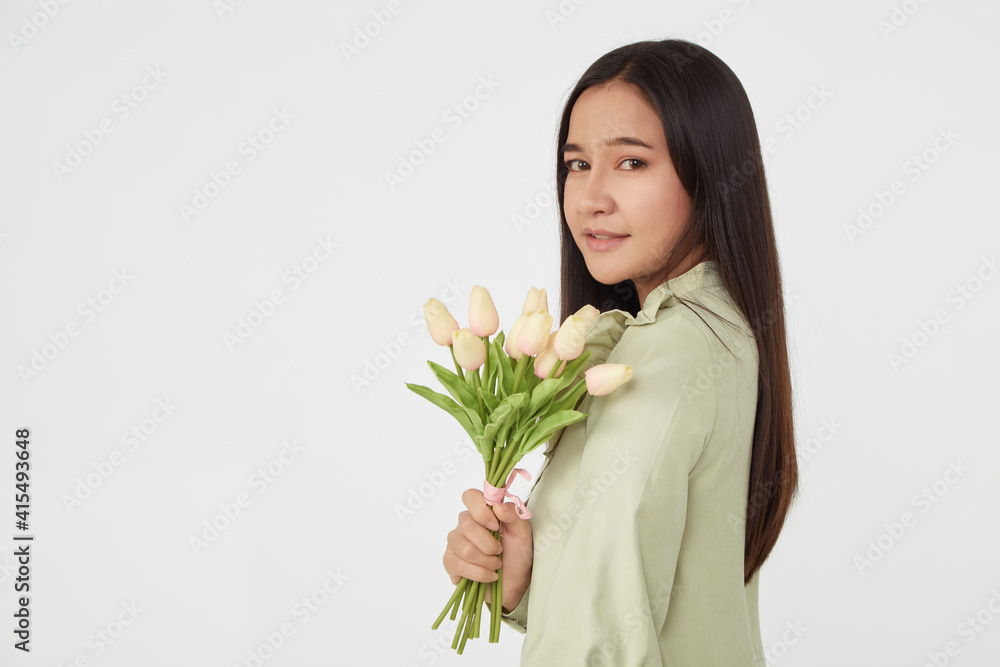 Spring Beautiful cheerful girl smiling and holding a bouquet of tulip flowers. Young happy woman. Surprise at the 8 March International Women's Day. Spring Beautiful cheerful girl smiling and holding a bouquet of tulip flowers. Young happy woman. Surprise at the 8 March International Women's Day.