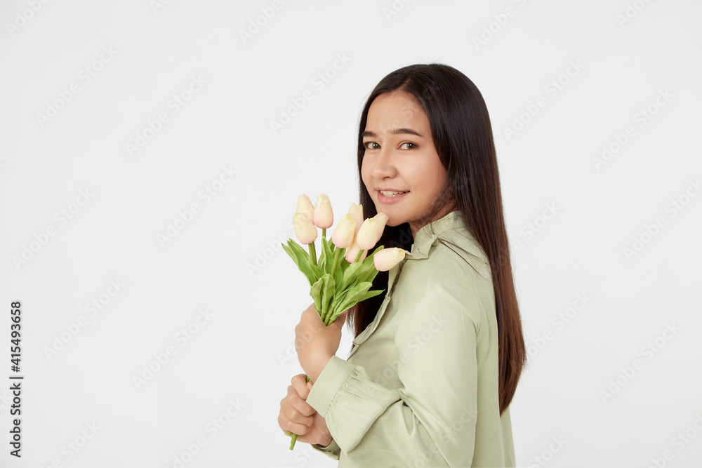 Spring Beautiful cheerful girl smiling and holding a bouquet of tulip flowers. Young happy woman. Surprise at the 8 March International Women's Day. Spring Beautiful cheerful girl smiling and holding a bouquet of tulip flowers. Young happy woman. Surprise at the 8 March International Women's Day.