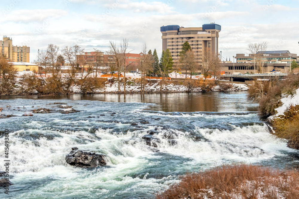 Downtown Spokane Washington, USA, and the Spokane River with light snow during winter.