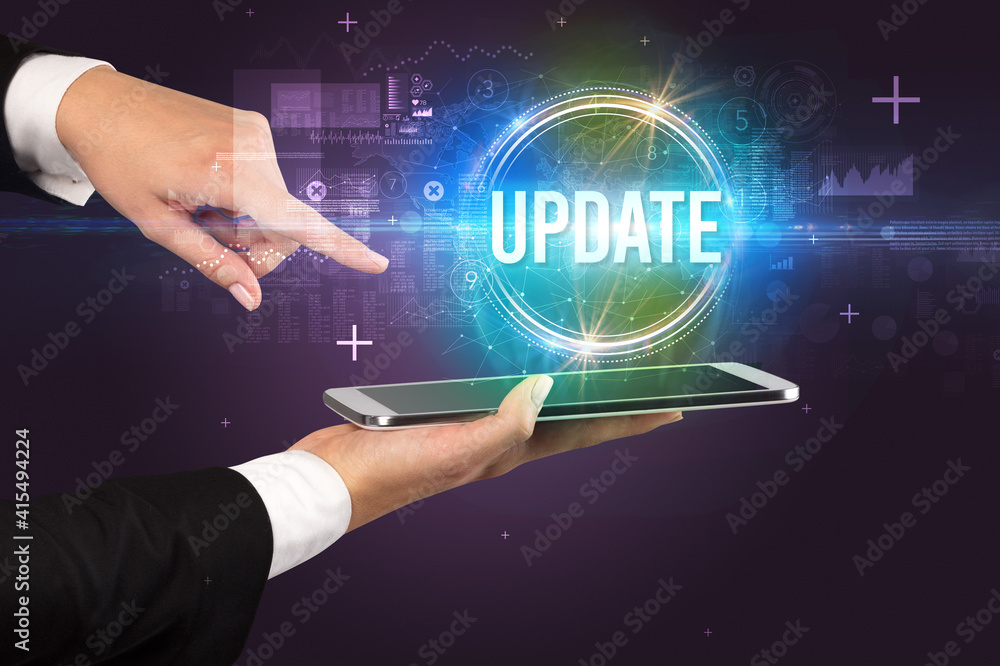 Fototapeta premium Close-up of a touchscreen with UPDATE inscription, new technology concept