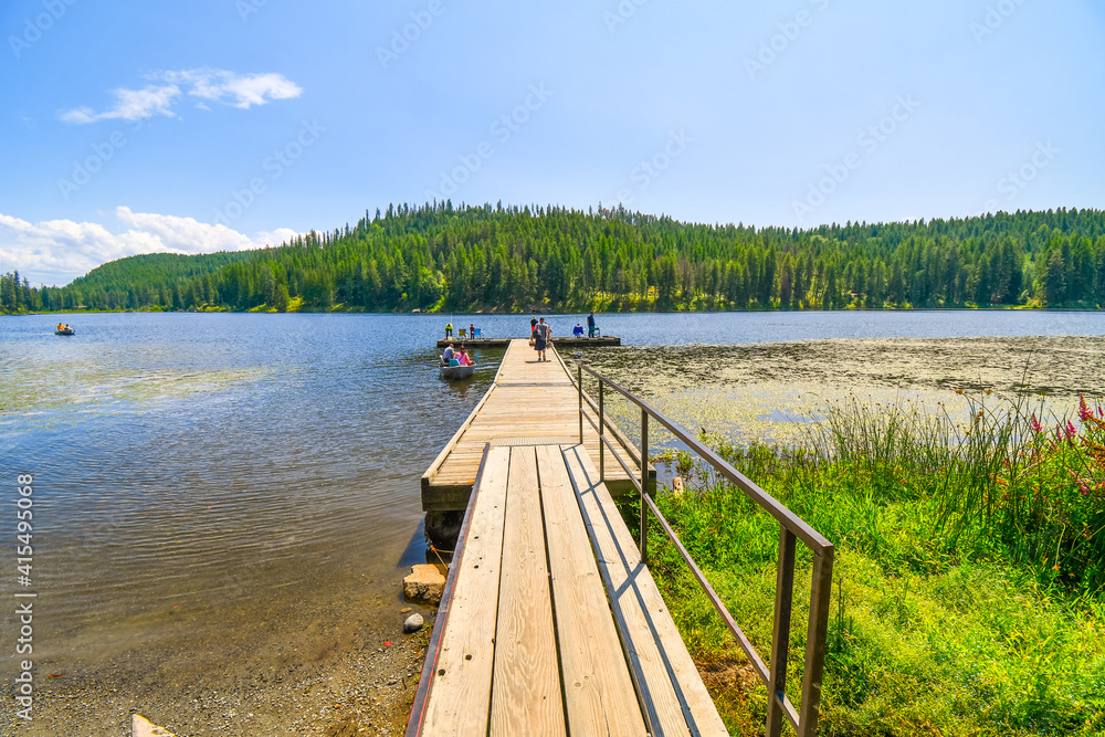Families enjoy a summer day of boating and fishing on Granite Kelso Lake in the Coeur d'Alene area of North Idaho, USA