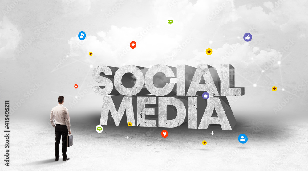 Young businessman standing in front of SOCIAL MEDIA inscription, social media concept Young businessman standing in front of SOCIAL MEDIA inscription, social media concept