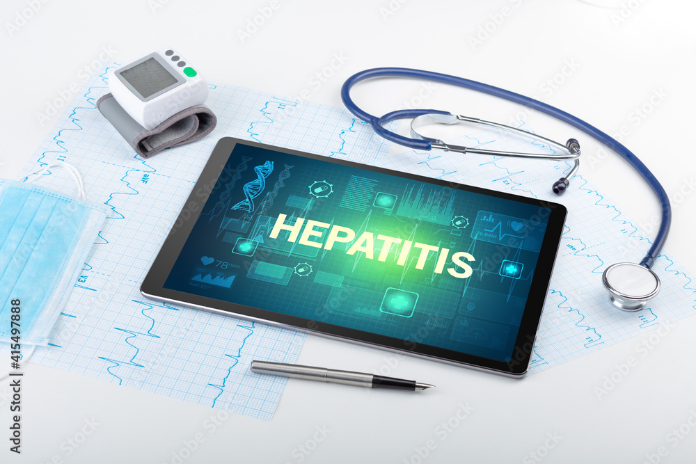 Tablet pc and medical stuff with HEPATITIS inscription, prevention concept Tablet pc and medical stuff with HEPATITIS inscription, prevention concept