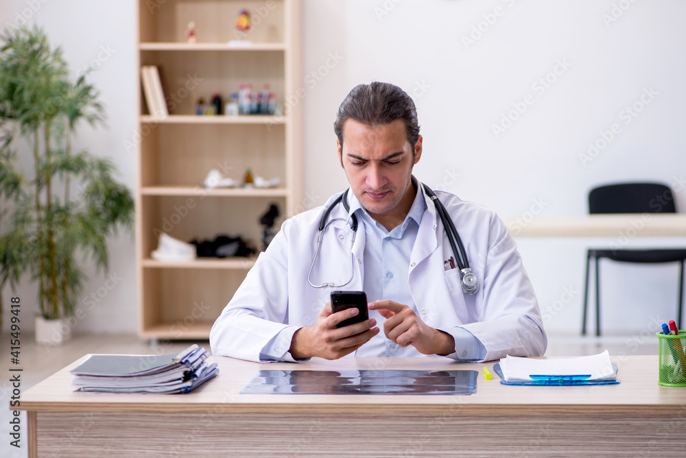 Young male doctor working in the clinic Young male doctor working in the clinic