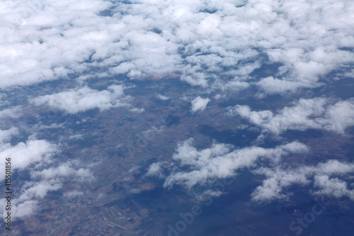 Fototapeta Naklejka Na Ścianę i Meble -  Flying above cumulus clouds and earth