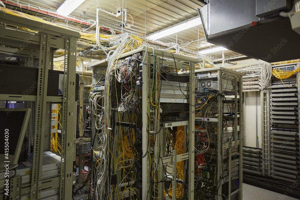 Wide angle background image of server room network with internet cables and wires in heaps, copy