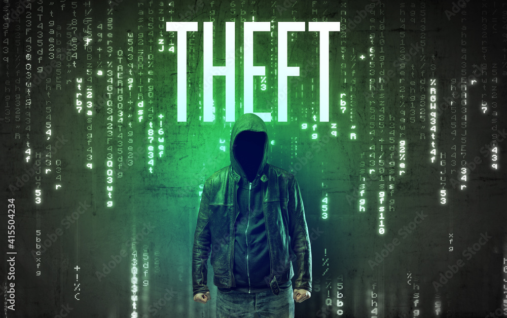 Faceless hacker with THEFT inscription, hacking concept Faceless hacker with THEFT inscription, hacking concept
