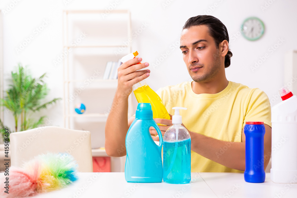 Young male contractor doing housework at home Young male contractor doing housework at home