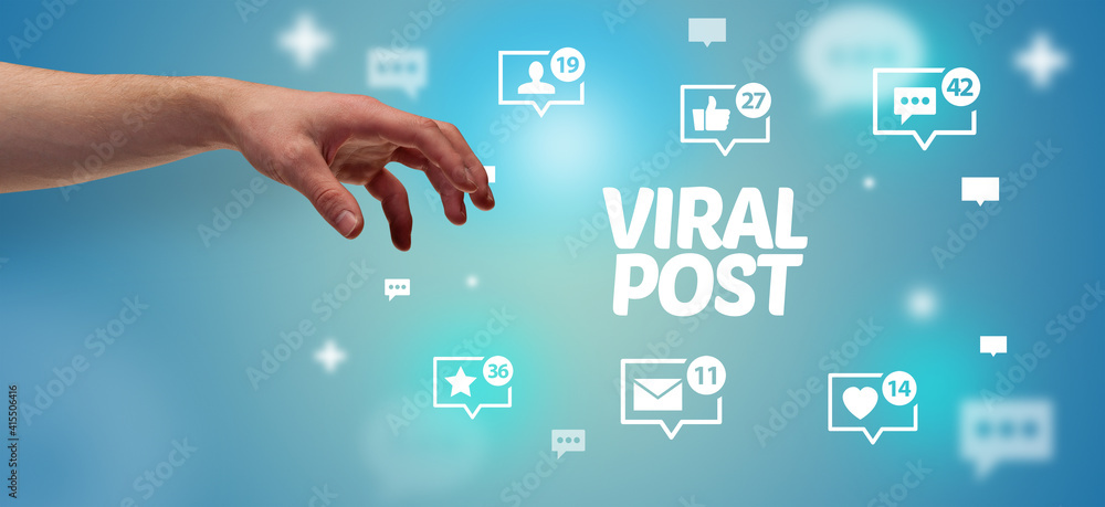 Close-Up of cropped hand pointing at VIRAL POST inscription, social networking concept Close-Up of cropped hand pointing at VIRAL POST inscription, social networking concept